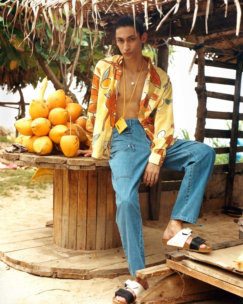 Embracing a tropical flair, Sami Younis wears a shirt, jeans, and card wallet by Jacquemus for Browns' spring-summer 2019 campaign. He also sports Rick Owens x Birkenstock sandals.