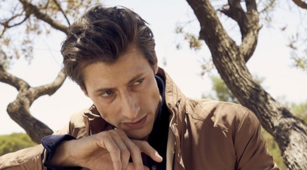 Jonas Mason Embraces Modern Gatsby Style in Brunello Cucinelli Jonas Mason dons a Brunello Cucinelli long moto jacket, unstructured blazer, and jersey western shirt.
