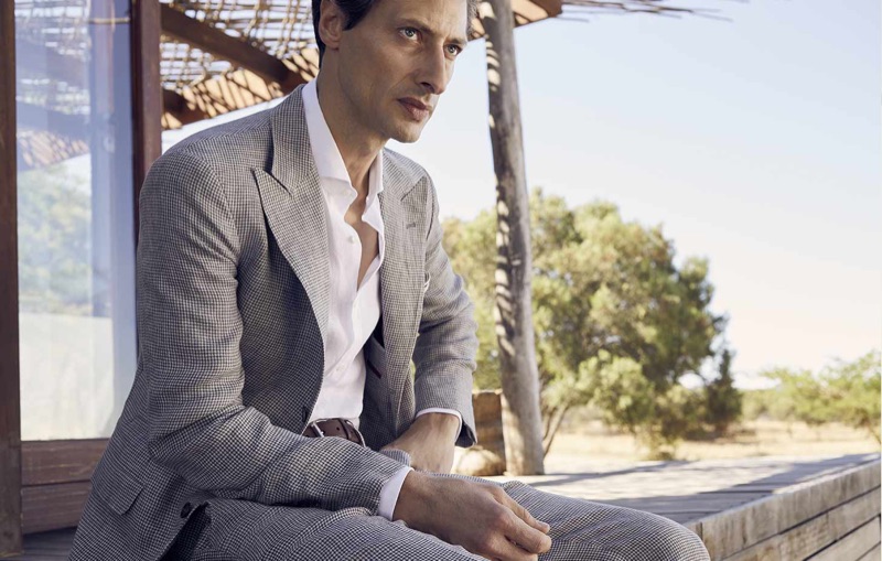 Model Jonas Mason sports a Brunello Cucinelli sport jacket and trousers with a solid woven shirt.