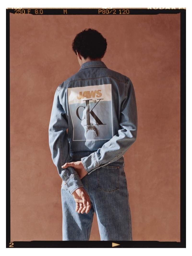 Front and center, Dylan wears a Calvin Klein 205W39NYC Jaws printed denim shirt with Maison Margiela denim jeans.