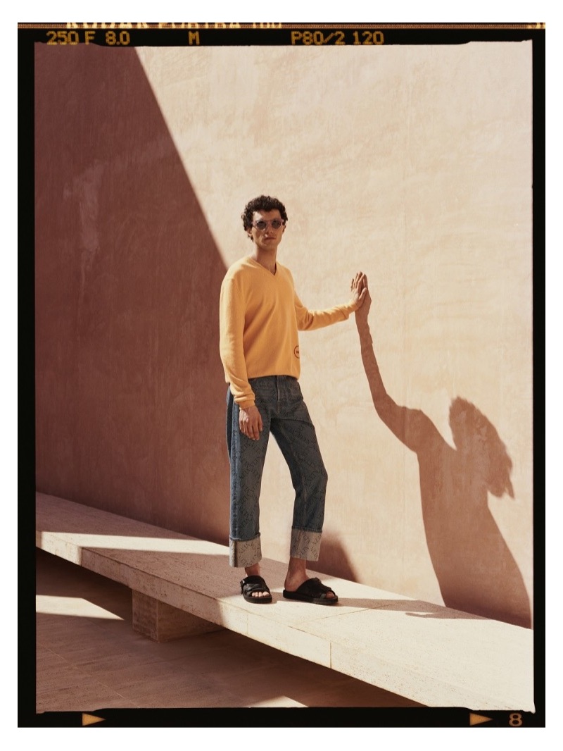 Ready for summer, Dylan wears a Calvin Klein 205W39NYC sweater with Valentino logo-print jeans and Prada slides.