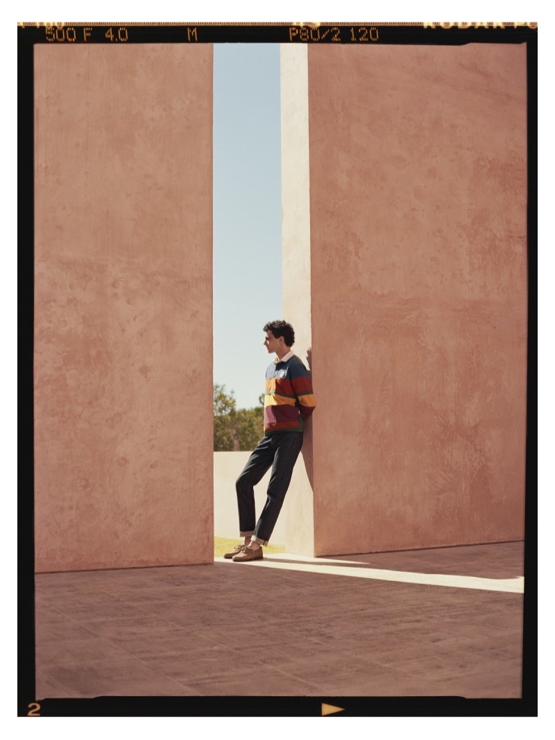 Connecting with Mr Porter, Dylan models an Aimé Leon Dore striped polo shirt with Mr P. denim jeans and suede boat shoes.