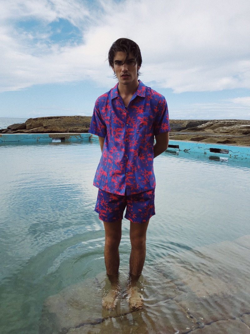 Cal Fernie models a Double Rainbouu short-sleeve Hawaiian shirt and swim shorts.