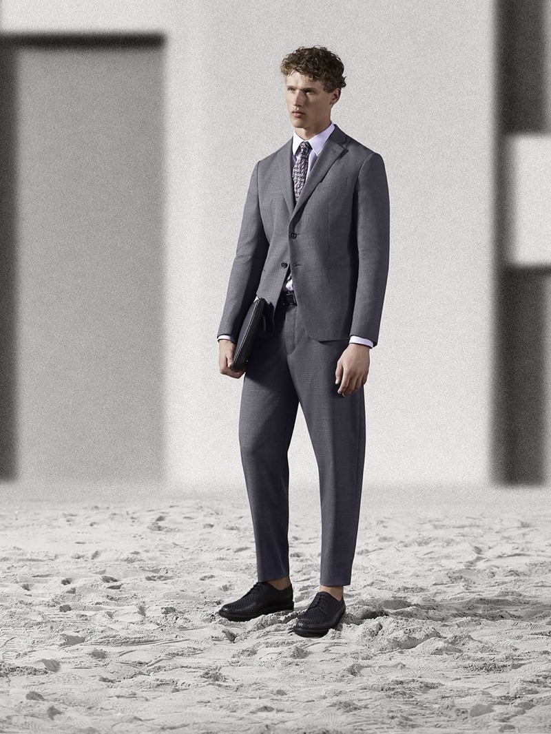 Front and center, Bram Valbracht dons an Emporio Armani suit.