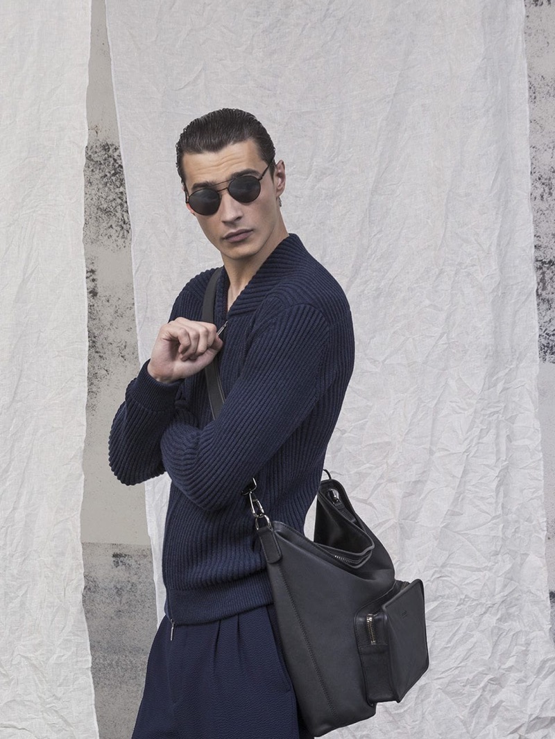 Adrien Sahores is chic in a navy outfit by Giorgio Armani.