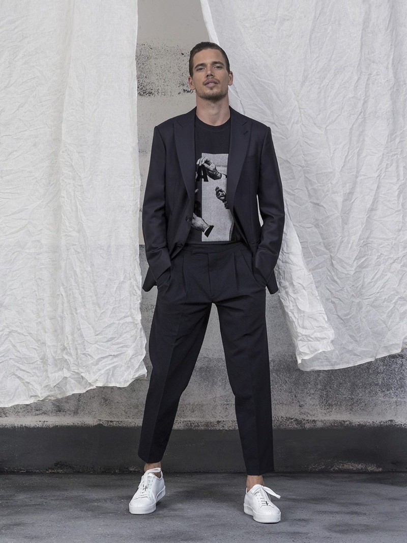 Model Mark Cox sports a Giorgio Armani suit with a tee and sneakers.