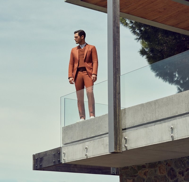 Embracing a rust-like color, Jislain Duval wears a tailored look from BOSS.