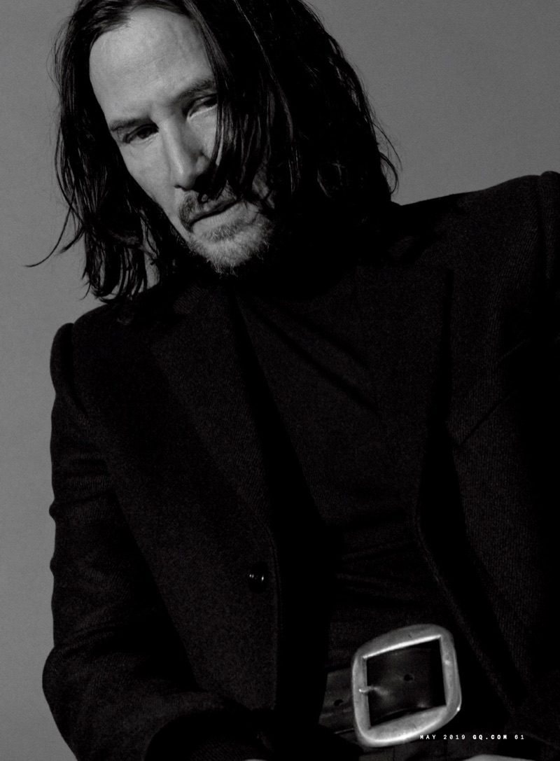 Actor Keanu Reeves wears a Saint Laurent coat, Bottega Veneta turtleneck, and Artemas Quibble belt.