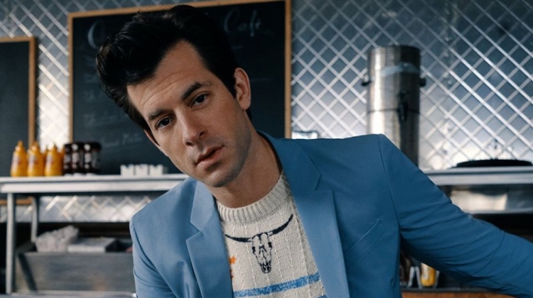 Front and center, Mark Ronson sports a light blue Prada suit with a Saint Laurent sweater.