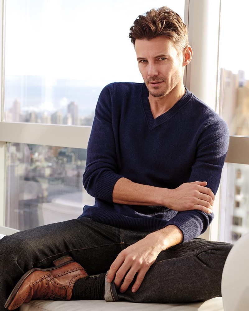 Relaxing, Alex Lundqvist wears a v-neck sweater by Naked Cashmere.