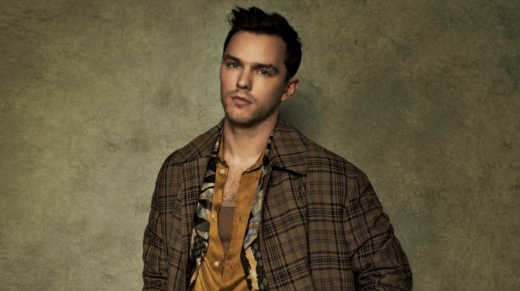 Front and center, Nicholas Hoult sports a check Hermès coat over a Roberto Cavalli coat. The actor also dons a Sean Suen shirt and Margaret Howell trousers with an Anderson's belt.