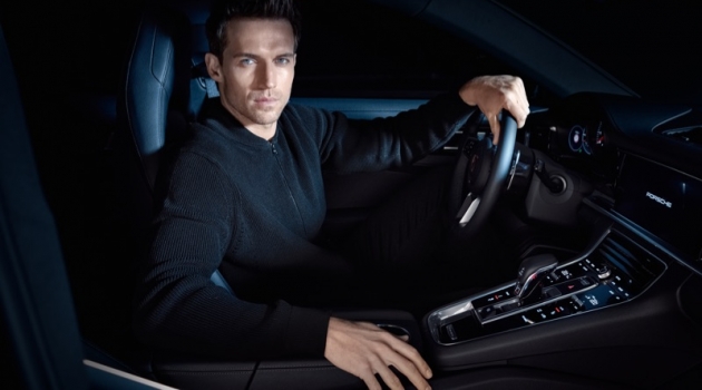 Porsche x BOSS Capsule Collection Launches Getting behind the wheels of a Porsche, Andrew Cooper wears an all-black look from the brand's BOSS capsule collection.