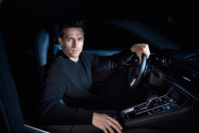 Getting behind the wheels of a Porsche, Andrew Cooper wears an all-black look from the brand's BOSS capsule collection.