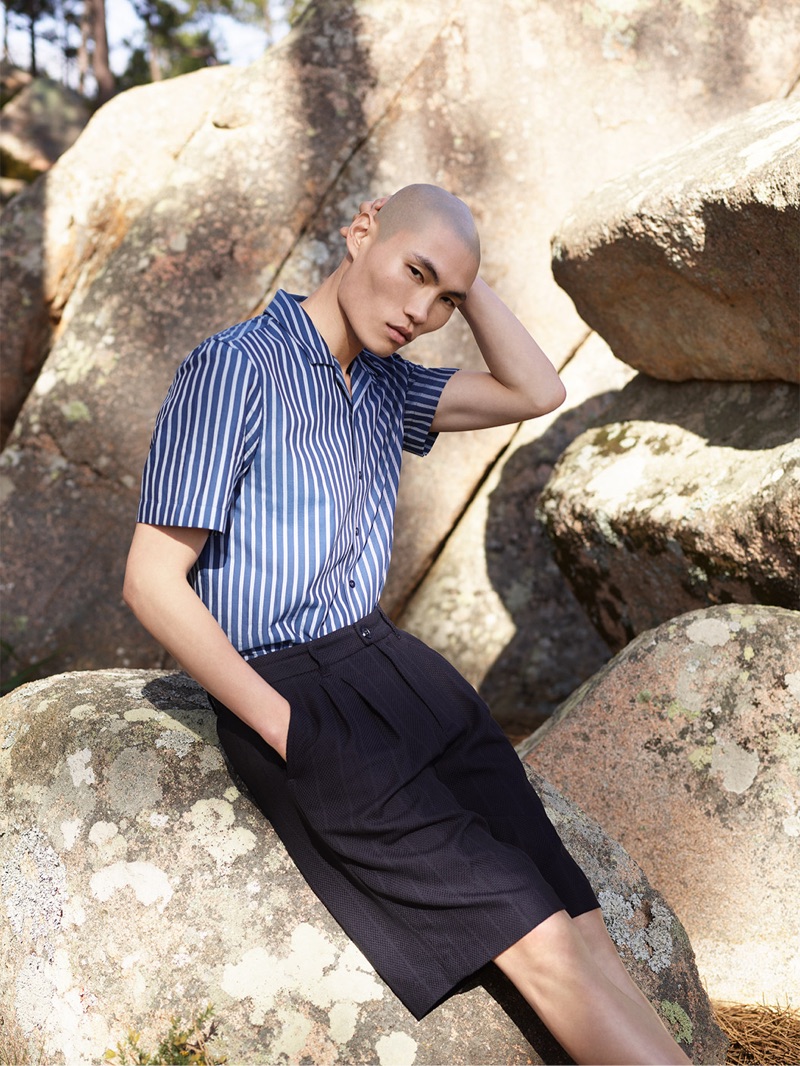 Ready for summer, Jean Chang sports a striped short-sleeve shirt with oversized tailored shorts from Reserved's Re.Design collection.