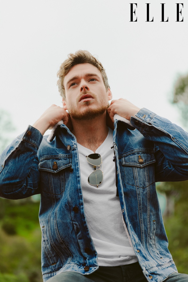Sporting a denim jacket, Richard Madden stars in a new photo shoot for Elle.