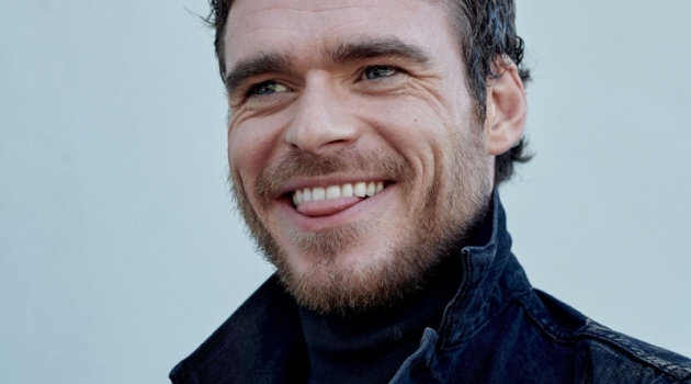 All smiles, Richard Madden wears a denim jacket by Levi's with a Prada turtleneck.
