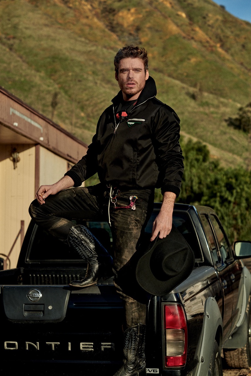 Actor Richard Madden wears a Prada jacket, Under Armour top, Saint Laurent jeans, and a Red Wing belt. He also rocks cowboy boots from The Universal Studios Costume Department.