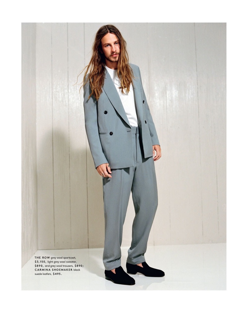 Front and center, Riley Hawk dons a double-breasted jacket, trousers, and sweater by The Row. He also wears suede loafers from Carmina Shoemaker.