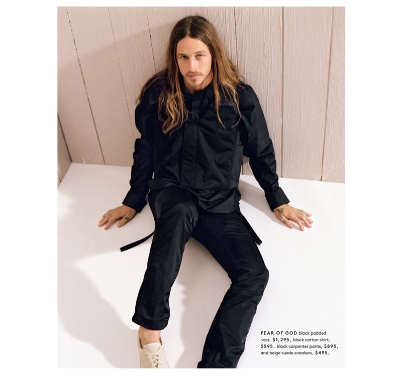 Skater Riley Hawk wears a padded vest, shirt, carpenter pants, and sneakers by Fear of God.