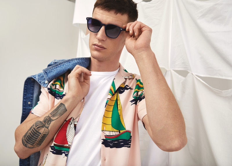 Ready for summer, Jack Buchanan wears a printed shirt with shades and a denim jacket from River Island.