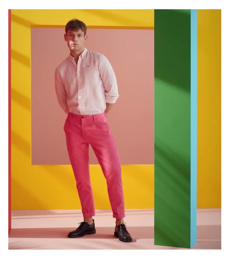 Embracing pink, Elliott Reeder sports a Scotch & Soda shirt and loose tapered fit trousers.