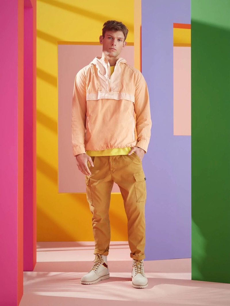 Sporting summer hues, Elliott Reeder wears a Scotch & Soda summer anorak and washed combat trousers.