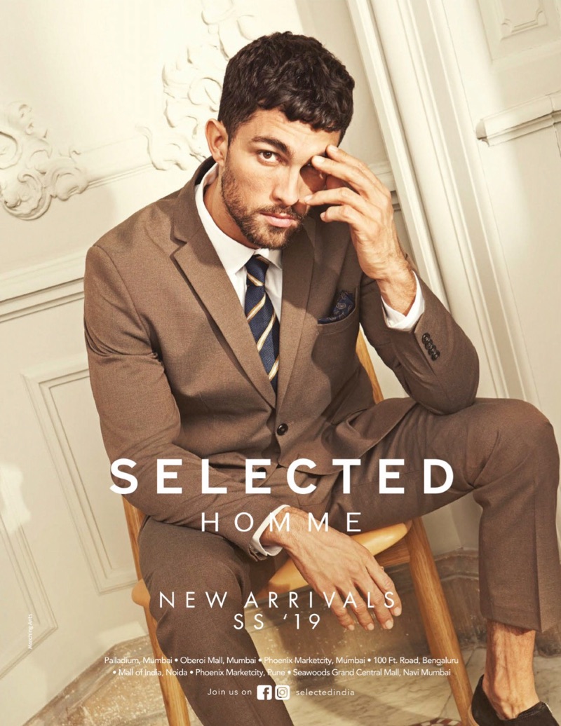 Donning a brown suit, Tobias Sorensen stars in Selected Homme's spring-summer 2019 campaign.