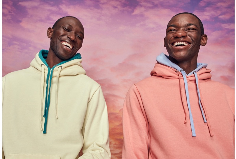 All smiles, Armando Cabral and Valentine Rontez wear pouch-pocket hoodies by LE 31.