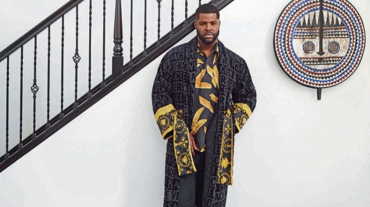 Winston Duke wears a Versace bathrobe, Dolce & Gabbana shirt, Saturdays New York sweatpants, and Falke socks.