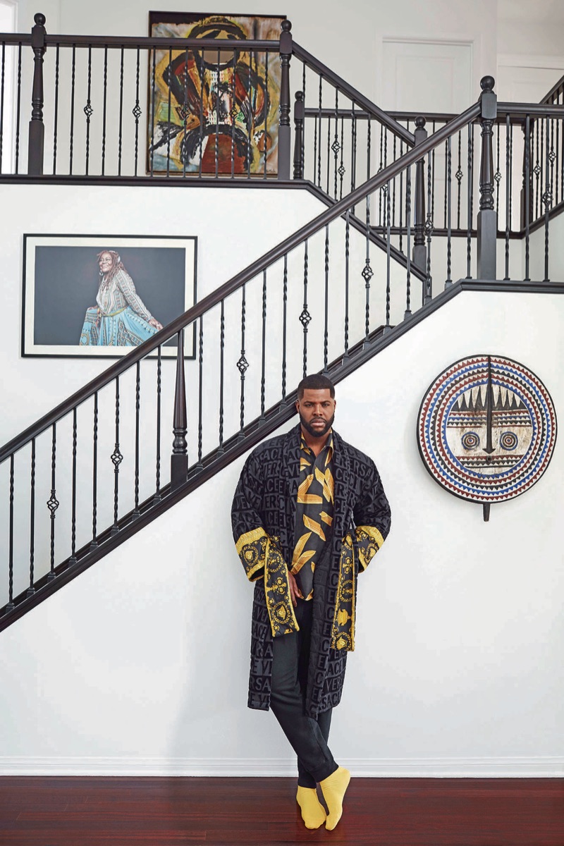 Winston Duke wears a Versace bathrobe, Dolce & Gabbana shirt, Saturdays New York sweatpants, and Falke socks.