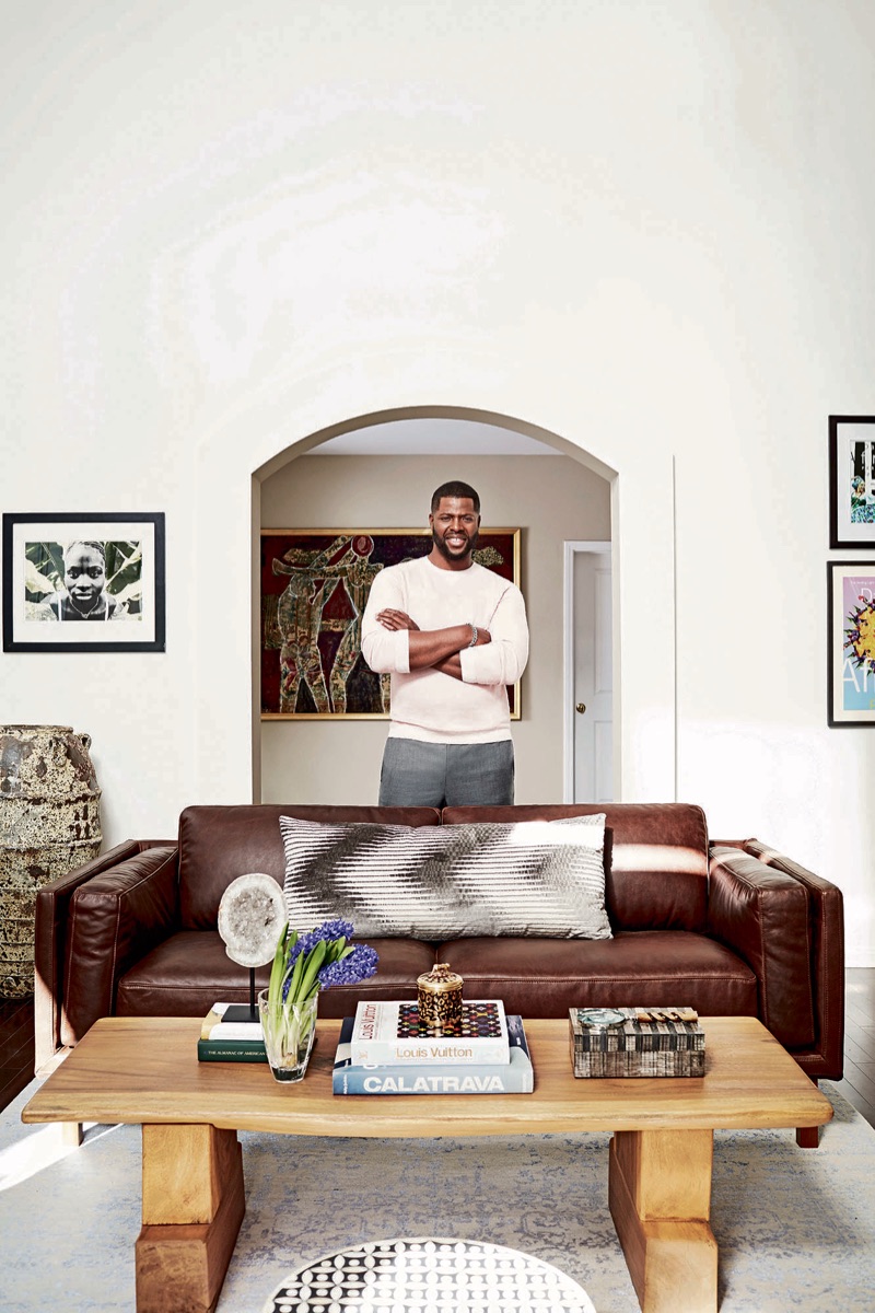 Front and center, Winston Duke dons an Ermenegildo Zegna sweater, Thom Browne trousers, David Yurman bracelet, and Louis Vuitton watch.