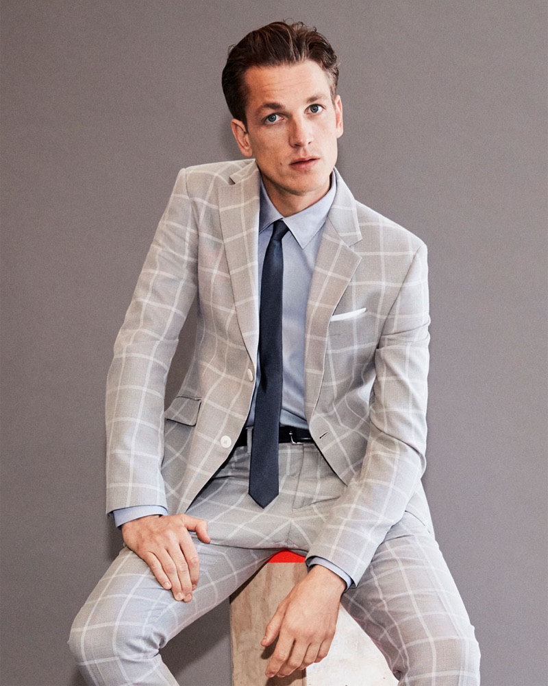 Front and center, Hugo Sauzay models a trim tailored suit from Zara Man.