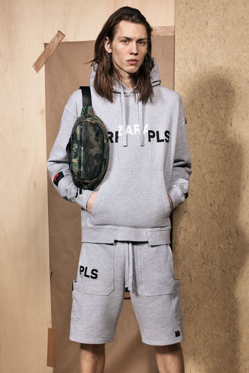 Going sporty, Sebastian Åhman wears a grey hoodie and sweat shorts from the Zara SRPLS collection.