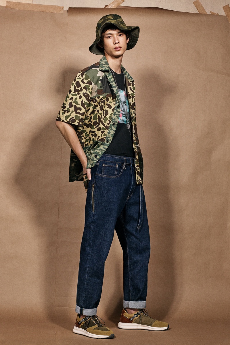 Yang Hao sports blue jeans and a camouflage shirt with bucket hat from the Zara SRPLS collection.