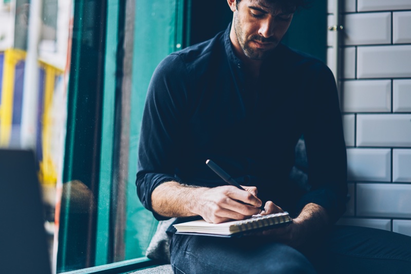 Attractive Man Writing Notebook