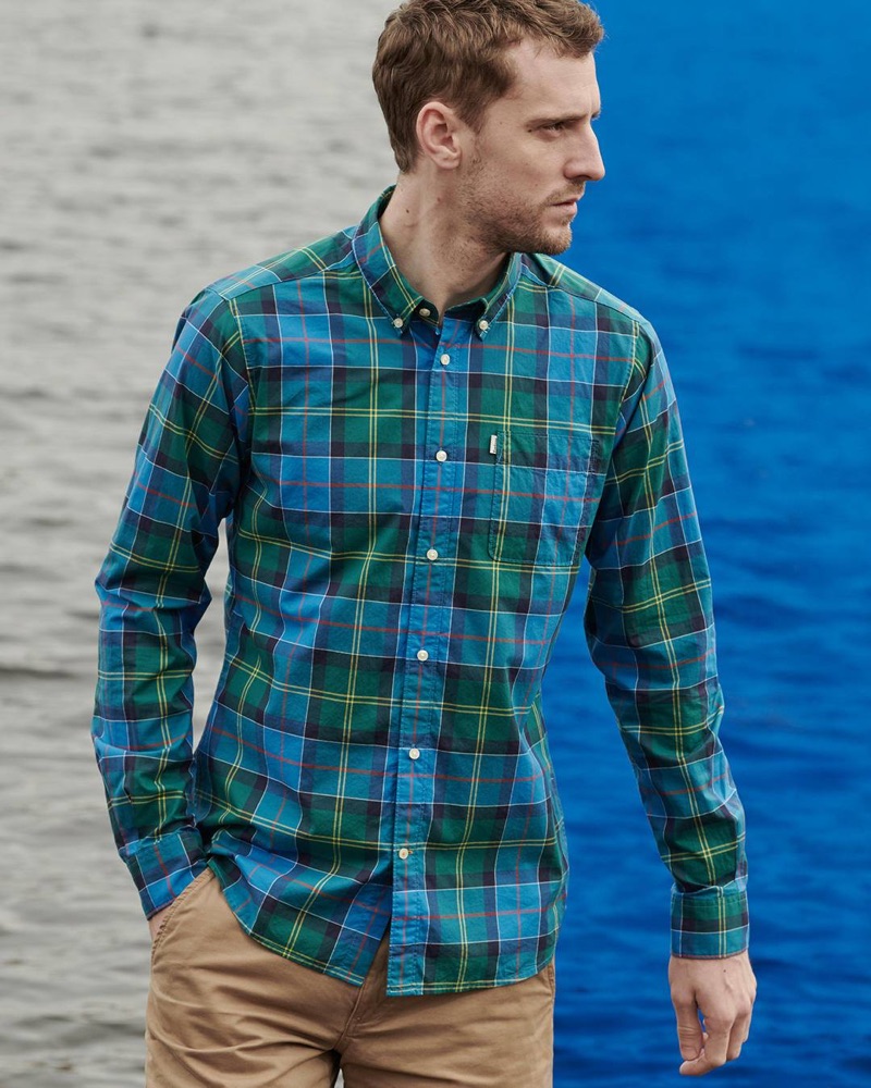 Reuniting with Barbour, George Barnett sports a blue and green shirt from the brand's spring-summer 2019 Pop Tartan collection.