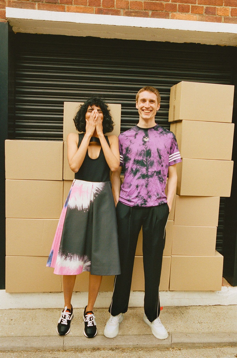 Posing for a picture with Radhika Nair, Michael Sharp wears an Adidas t-shirt, Ader Error trousers, and sneakers from Stadium Goods.