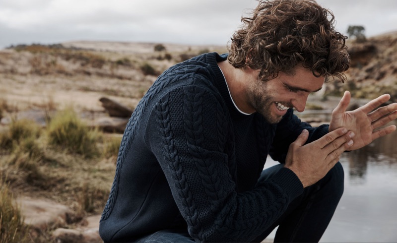 Donning a cable-knit sweater, Alex Libby wears Country Road.