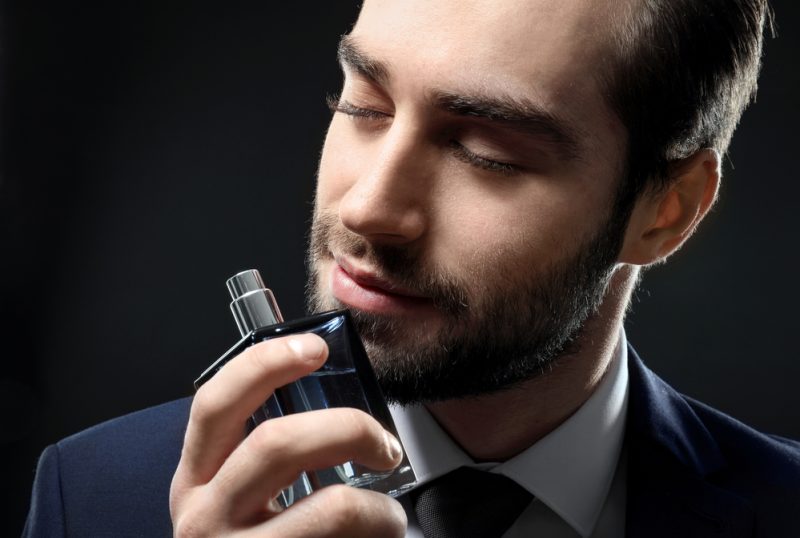 Dapper Man in Suit with Cologne Bottle Dapper Man in Suit with Cologne Bottle