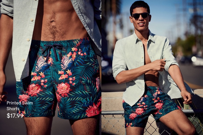 Embracing summer style, Geron McKinley sports tropical print swim shorts with a shirt by H&M.
