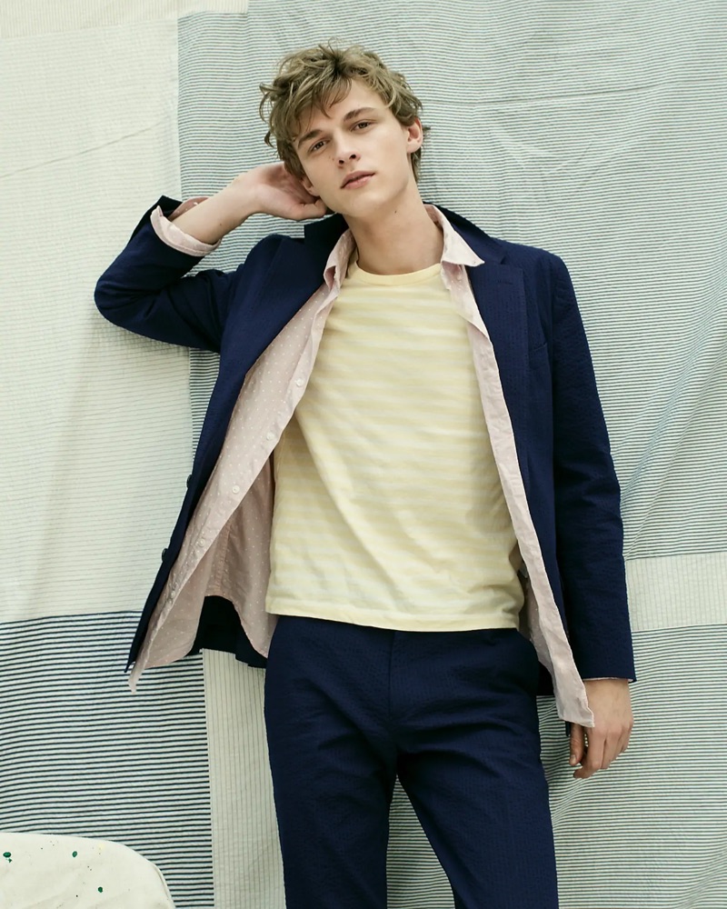Embracing pastels, Max Barczak wears a J.Crew navy Ludlow slim-fit unstructured blazer and pants in stretch seersucker. He also sports J.Crew's dot print heathered shirt and striped essential crewneck t-shirt.