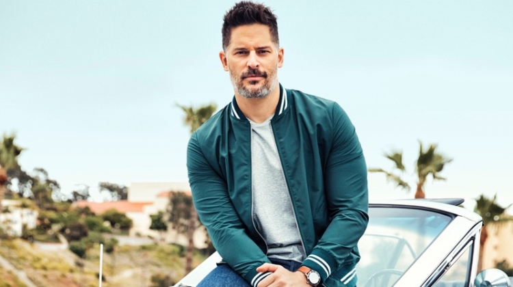 Actor Joe Manganiello wears an Eleventy jacket, Calvin Klein t-shirt, Levi's jeans, and Converse sneakers with a Movado watch.