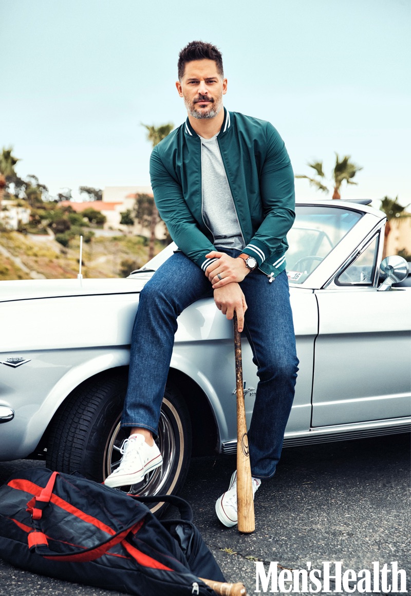 Actor Joe Manganiello wears an Eleventy jacket, Calvin Klein t-shirt, Levi's jeans, and Converse sneakers with a Movado watch.