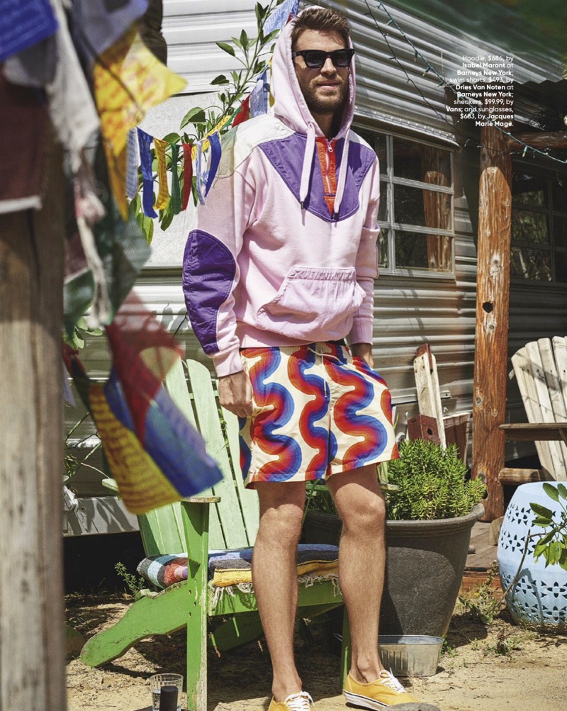 Mixing graphics, Liam Hemsworth rocks an Isabel Marant hoodie, Dries Van Noten swim shorts, Vans sneakers, and Jacques Marie Mage sunglasses.