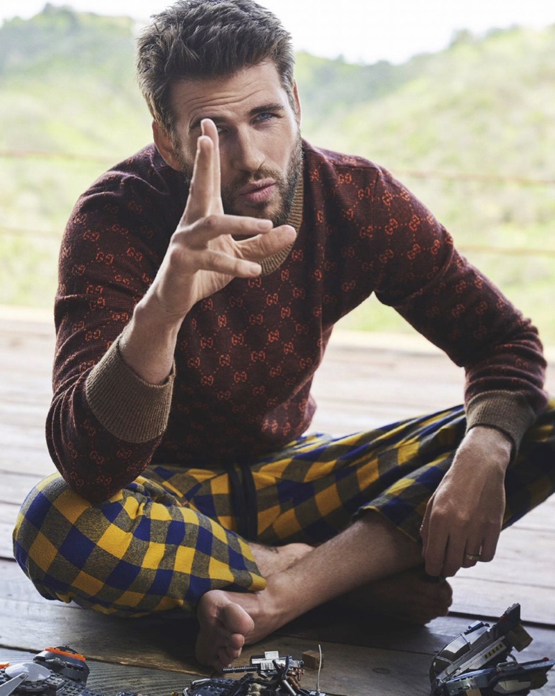 Actor Liam Hemsworth wears a Gucci sweater with checked Double Rainbouu pants.