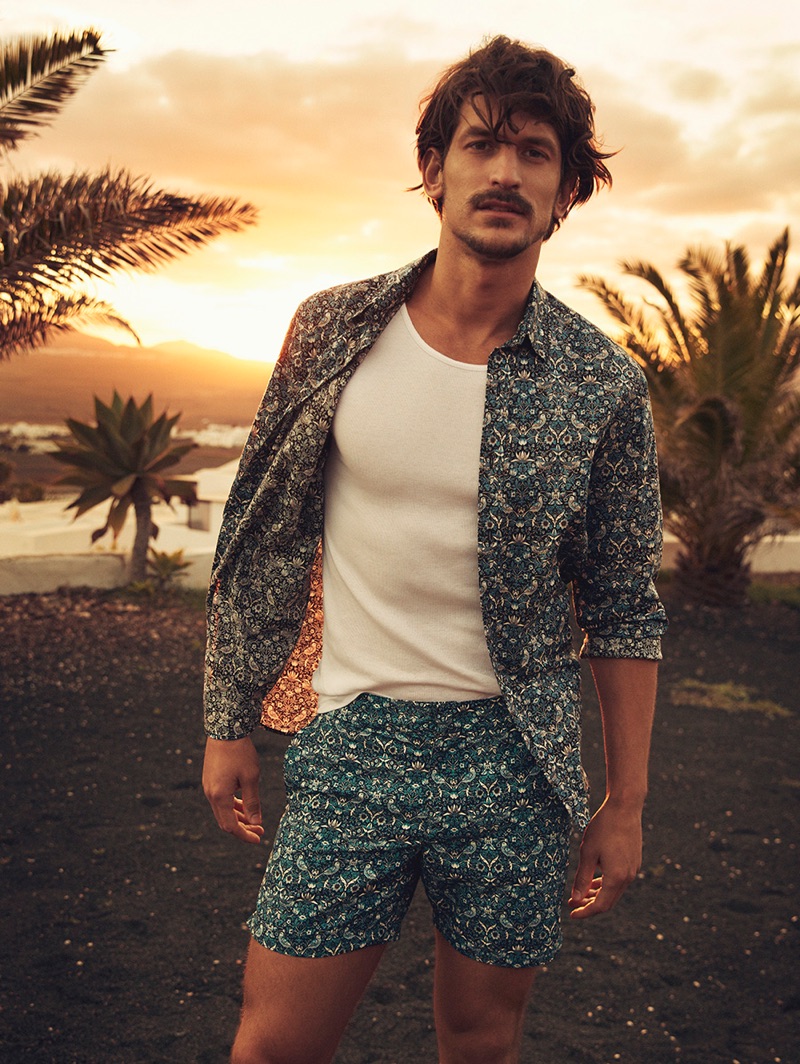 Jarrod Scott models a shirt and shorts from Liberty London's travel and swim collection.