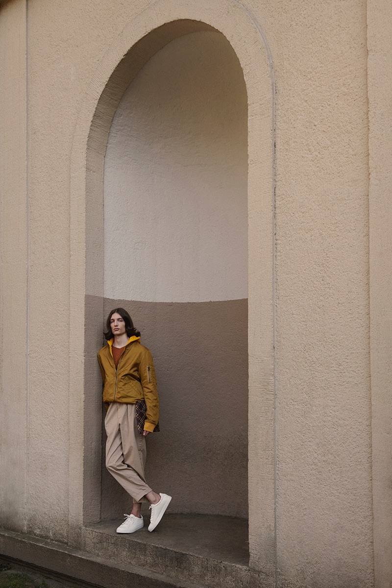 Lucian wears pullover Joseph, bomber Scotch & Soda, trousers Pringle of Scotland, shoes Common Projects, and vintage bag stylist's own.