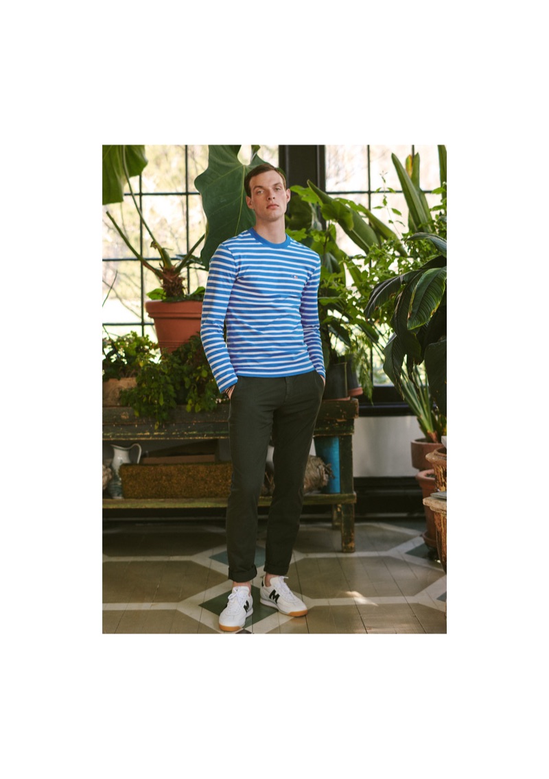 Rocky Harwood dons a striped Maison Kitsuné tee with Theory pants and Karhu ChampionAir sneakers. He also sports Miansai's bracelets. 