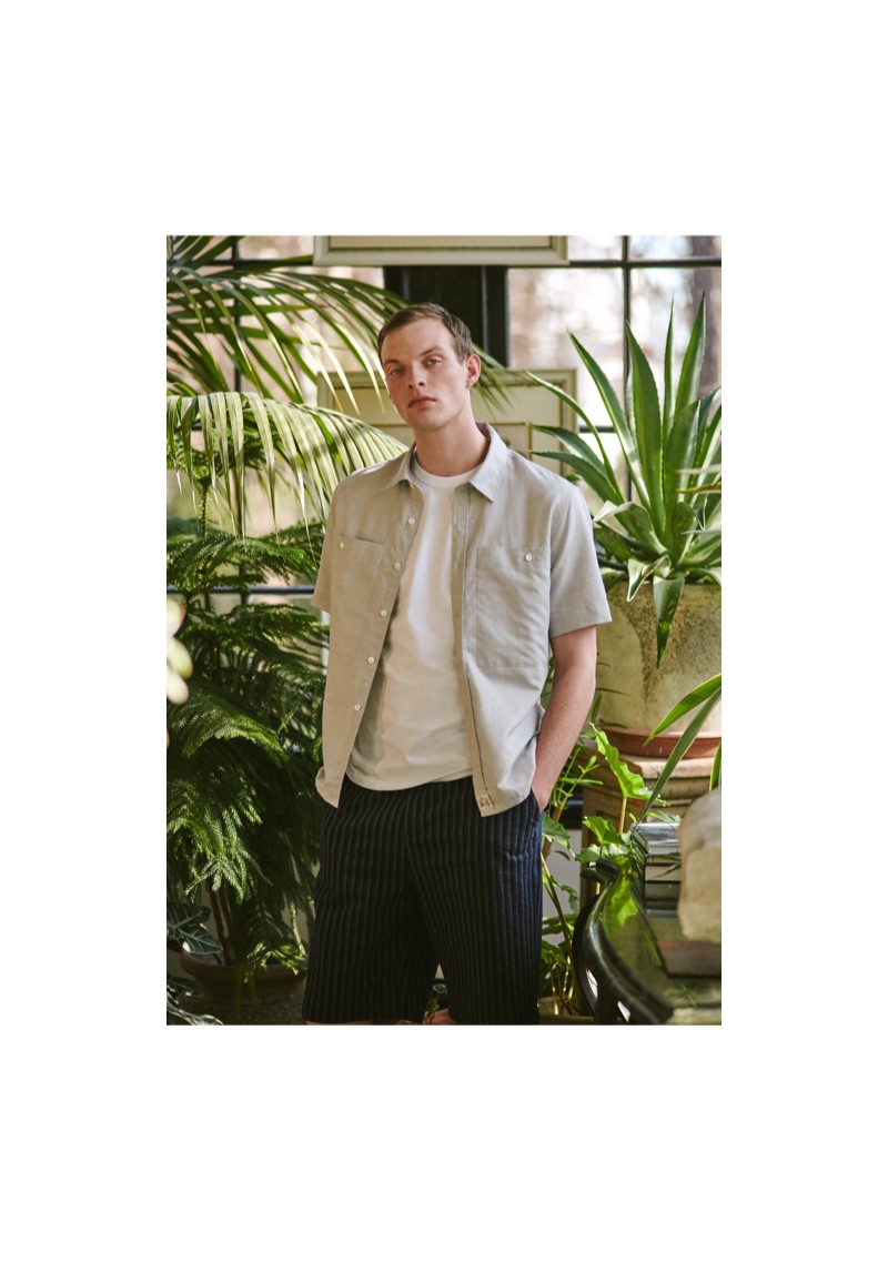 Model Rocky Harwood wears a Maison Kitsuné shirt, t-shirt, and seersucker shorts.