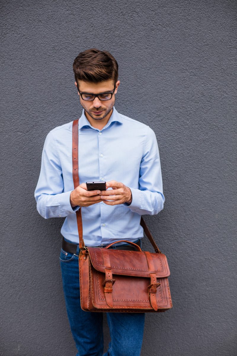 Man on Cellphone Glasses Leather Messenger Bag